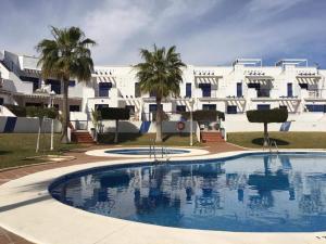 a large swimming pool in front of a building at Sunny Breeze Apartment in Mojácar
