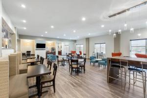 a restaurant with tables and chairs and a cafeteria at Sleep Inn & Suites South Jacksonville in South Jacksonville