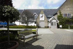 a bench sitting in front of a building at Breckland Lodge in Attleborough