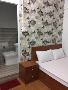 a small room with a bed and a bathroom at BangBang Motel in Can Tho