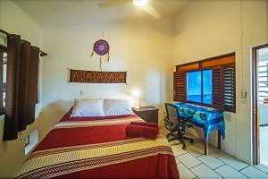 a bedroom with a bed and a desk in it at Casa Lucas in Sayulita +21 photos