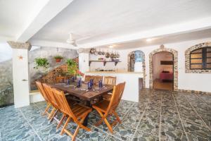 a dining room with a wooden table and chairs at Casa Lucas in Sayulita