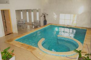 a large swimming pool in a large room at Hotel Cabo Santa Maria in La Paloma
