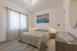 a bedroom with a bed and a desk and a window at Casa Angela Rosa in Carovigno