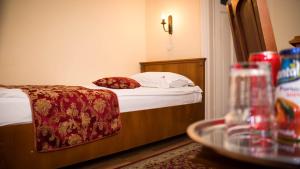 a hotel room with a bed with a red blanket at Hotel Transilvania in Cluj-Napoca