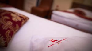 a close up of a bed with a red sign on it at Hotel Transilvania in Cluj-Napoca