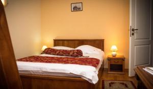 a bedroom with a bed with two pillows on it at Hotel Transilvania in Cluj-Napoca