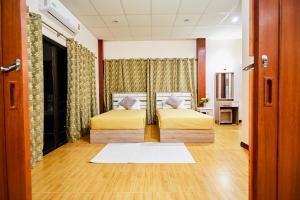 a bedroom with a bed with yellow sheets at The Sun House in Hua Hin +134 photos