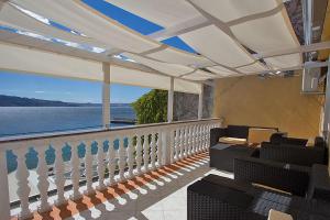 a balcony with chairs and a view of the water at Apartment Carlitos in Karlobag
