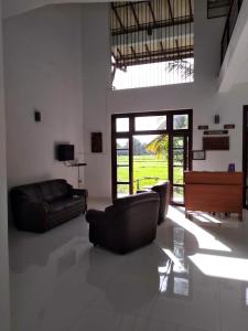 a living room with a couch and a piano at Serene View Tourist Rest in Anuradhapura