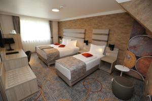 Säng eller sängar i ett rum på Hotel Baril