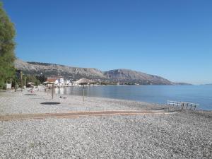 a rocky beach with benches and the water at Seafront Studios and Apartments in Chios