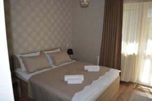 A bed or beds in a room at Kazbegi Inn
