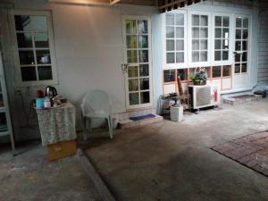 a porch of a house with a table and a chair at Social Style Culture in Bangkok