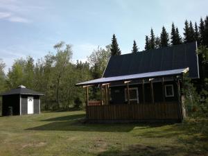 a house with a black roof and a smallshed at Nix at Gammel Rye in Ry