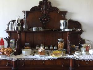 a table with food on top of a wooden shelf at Villa Eugenia in Livorno