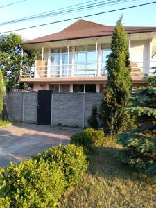 a house with a fence in front of it at Тownhouse99 in Petropavlovskaya Borshchagovka