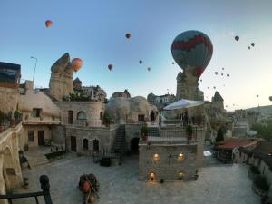 a group of hot air balloons flying in the sky at Grand Cave Suites in Goreme