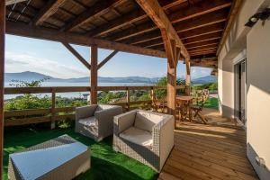 a porch with chairs and a table and a view of the ocean at T2 vue sur le golfe d'Ajaccio in Porticcio