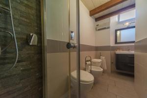 a bathroom with two toilets and a shower at Casa Vacanze Belleville in Trani