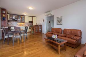 a living room with a couch and a table at Otium in Kaštela
