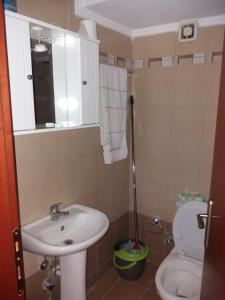 a small bathroom with a sink and a toilet at Jordan's Neoi Epivates Appartment by the Beach in Neoi Epivates +20 photos
