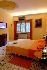 a bedroom with a large bed and a television at B&B Tiburtina Garden in Rome