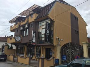 a large yellow building with a sign on it at Villa Konzuli in Bitola