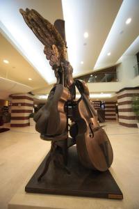 a statue of an angel playing a violin at Flamingo Grand Hotel & Spa in Albena