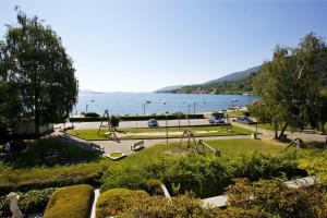 a park with a playground and a view of the water at Residenz La Vela in Baveno