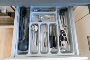 a tray filled with utensils in a drawer at Apartment Schneeburg in Ebringen