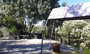 a pavilion with chairs and trees in a park at Casa Masseria Le Ville in Peschici
