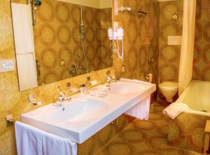 a bathroom with a sink and a toilet at Hotel St. Pankraz in San Pancrazio dʼUltimo