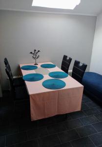 a table with black chairs and a table with blue at Santos in Kappel-Grafenhausen