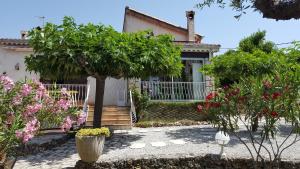 a house with trees and flowers in front of it at entre mer et verdon in Draguignan