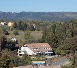 a house in the middle of a forest with a road at Hotel Pian del Sole in Sassello