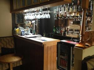 a bar with a lot of bottles of alcohol at Bluebell Hotel in Blackpool