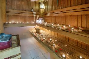 a row of wooden benches in a sauna with candles at Grand Excelsior Hotel - Bur Dubai in Dubai