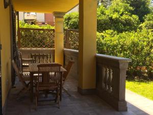 a patio with a table and chairs on a porch at Appartamenti fronte mare in Castiglioncello