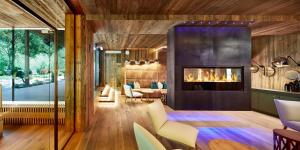 a living room with a fireplace in a house at ZillergrundRock Luxury Mountain Resort in Mayrhofen +199 photos