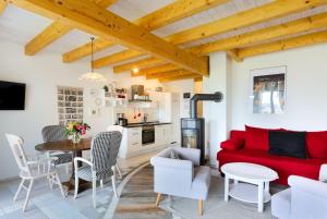 a living room with a red couch and a table at Plau Lagoons in Plau am See