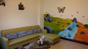a living room with a couch and a painting on the wall at 168 Living Water in Dongshi
