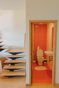 a staircase leading to a bathroom with a toilet at Sunrise House in Ponta Delgada