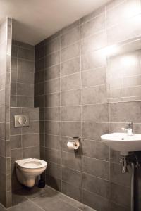 a bathroom with a toilet and a sink at Amsterdam Hostel Orfeo in Amsterdam