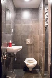 a bathroom with a toilet and a sink at Amsterdam Hostel Orfeo in Amsterdam