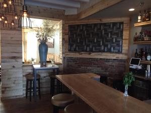 a bar in a restaurant with a brick wall at Roam Inn in Munising