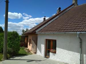 a small white house with a brown roof at NOVODVORSKÝ APARTMÁN SÁRA in Nové Dvory