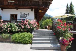 a set of stairs with flowers in front of a building at Gästehaus Gratlspitz in Alpbach