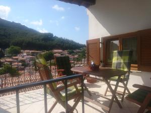 a balcony with a table and chairs and a view at Samothraki in Samothraki