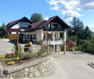 a house with a fence in front of it at Frankovič Bed&Breakfast in Vinica